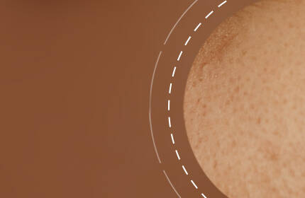 An abstract image featuring a close-up of skin texture against a brown background, with a circular design element.