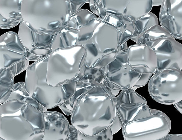 Des particules reflechissantes en forme de spheres et de cubes, flottant sur un fond noir, creant un effet de profondeur.