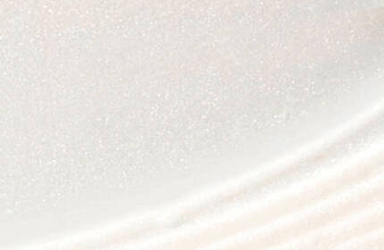 Close-up of a smooth, glossy surface with subtle shimmering and curved patterns.
