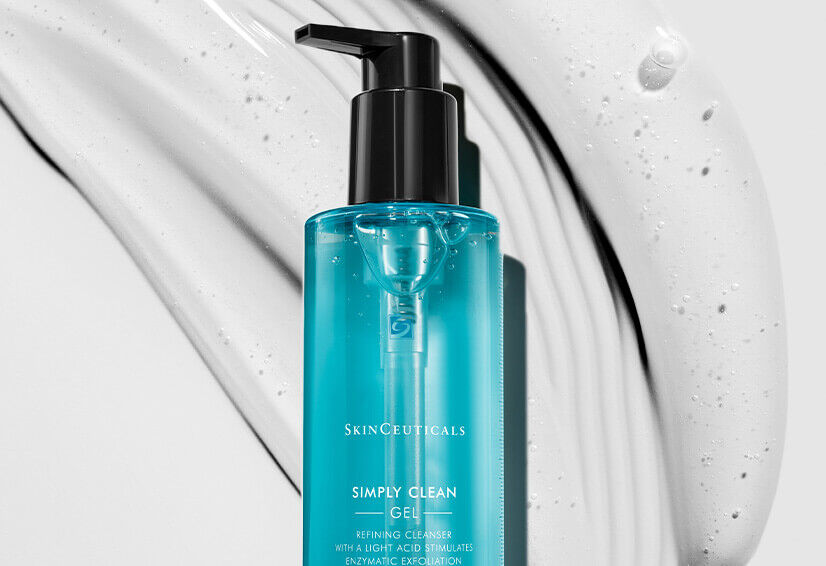 A blue SkinCeuticals Simply Clean Gel bottle on a white, swirled background, showcasing its sleek design and cleansing properties.