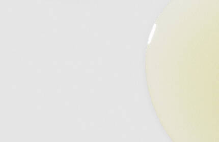 Two amber glass bottles of SkinCeuticals C E Ferulic serum, positioned against a light blue background.