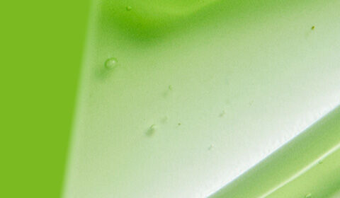 Abstract design featuring a gradient of vibrant green shades with smooth, flowing textures.