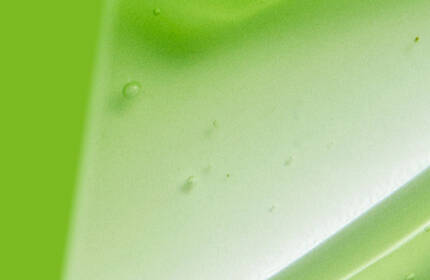 Abstract design featuring a gradient of vibrant green shades with smooth, flowing textures.