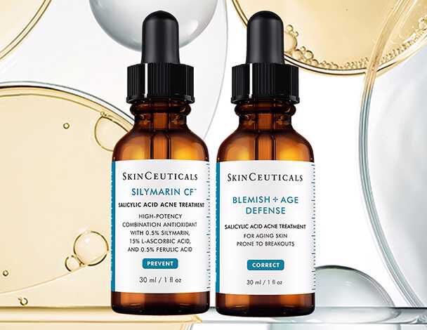 Twee flessen met serums van SkinCeuticals: een met Silymarin CF en de andere met Blemish + Age Defense, beide in glazen flacons met pipetten.