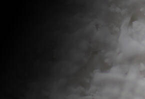 Abstract image featuring soft, swirling textures in white and gray tones, creating a sense of movement and depth.